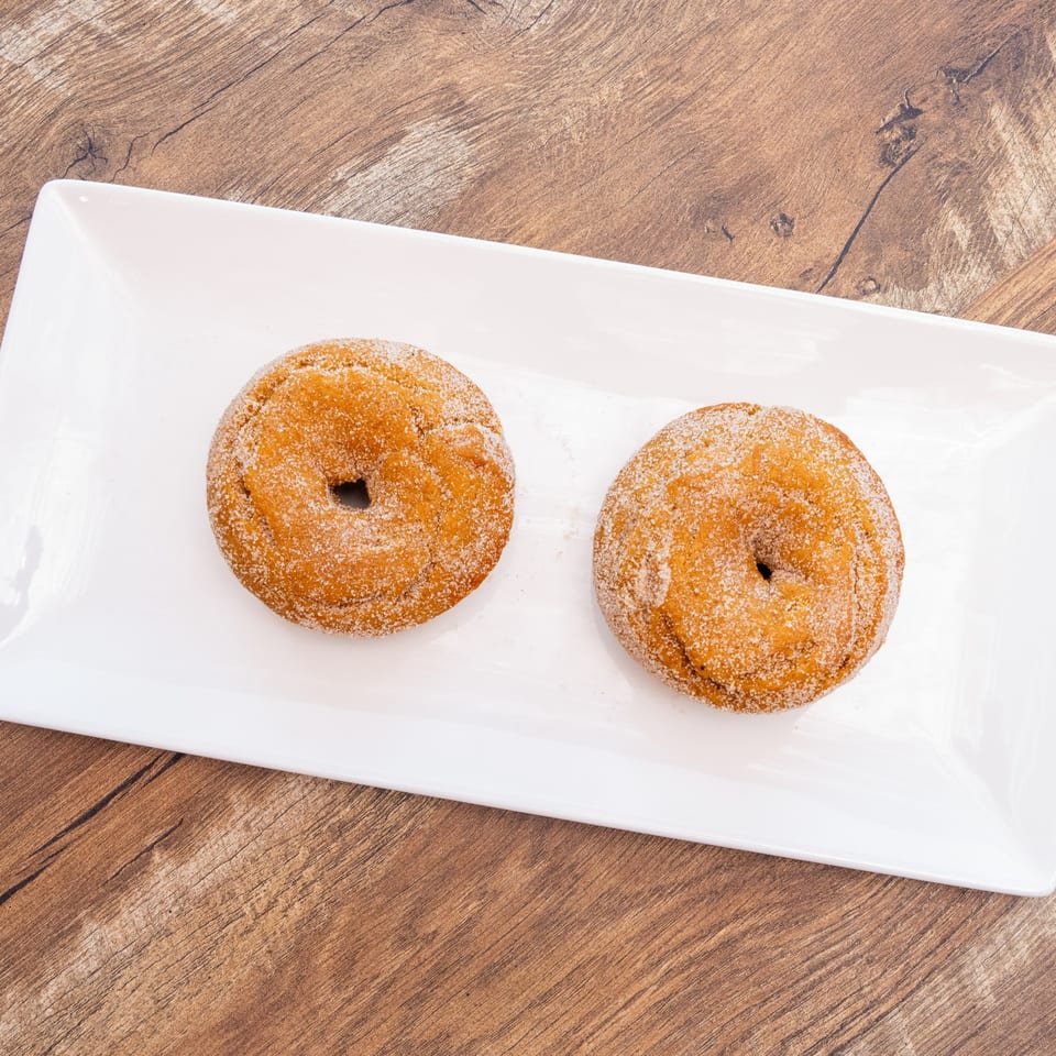 Two sugar-coated doughnuts.